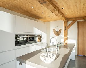 Villa 189 with Hot tub in De Koog, Texel features an open kitchen with garden views.