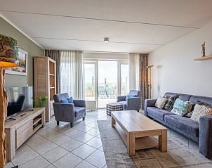 Spacious living room in Apartment - 4-persons (1535), De Koog, Texel with cozy furnishings and views of the terrace.