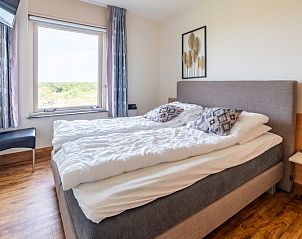 Bedroom in Apartment Juliana 168 Zeezicht, De Koog Texel, with comfortable bed and nature view.