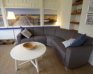 Comfortable sitting area in Grand Hotel Opduin - Holiday home C, De Koog, Texel, with attractive decorations and beach picture.