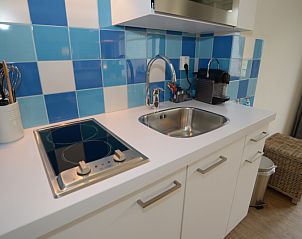 Stylish kitchen corner in Grand Hotel Opduin - Holiday home C, De Koog, Texel, with modern appliances and colorful tiles.
