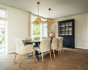 Elegant dining room of Villa 25a in De Koog Texel, vacation home with comfortable chairs, Wadden Islands.