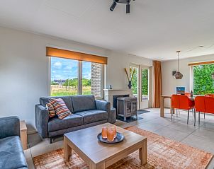 Open living space in Holiday home Honeysuckle 69 with sauna, De Koog, Texel, with access to the terrace and views of nature.