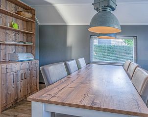Dining room of Holiday home Honeysuckle 87 in De Koog Texel with large wooden dining table.