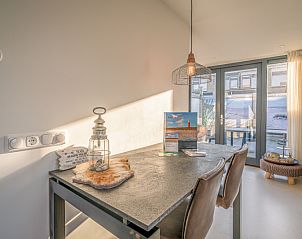 Dining room at Het Bospad - Brink 15, De Koog, Texel. Cozy dining overlooking the Wadden Islands terrace.