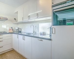 Modern kitchen in Holiday home Honeysuckle 31, De Koog, Texel, with sleek white cabinets and built-in appliances.