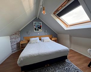 Spacious bedroom in Texel C vacation home, De Koog, Texel, with large skylight and cozy atmosphere.