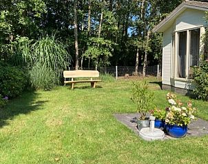 Rustic garden with bench at Holiday home in De Koog, Texel, Wadden Islands.