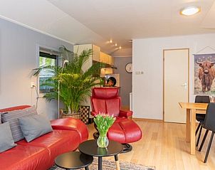 Modern living room with red sofa in Holiday home in De Koog, Texel, Wadden Islands.