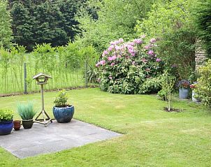 Large garden with colorful flowers at Holiday home in De Koog, Texel, Wadden Islands.