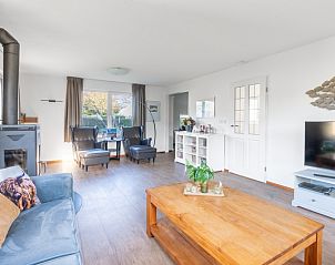 Spacious living room with wood stove in Holiday home Honeysuckle 75, De Koog, Texel.