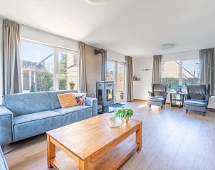 Comfortable sitting area with wood stove in Holiday home Honeysuckle 75, De Koog, Texel.
