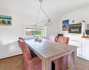 Dining area in Holiday home Honeysuckle 75, De Koog, Texel with modern kitchen facilities.