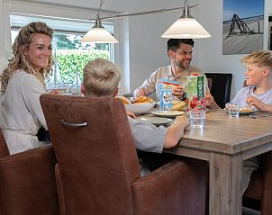 Family meal in the dining room of Holiday home Honeysuckle 75, De Koog, Texel.