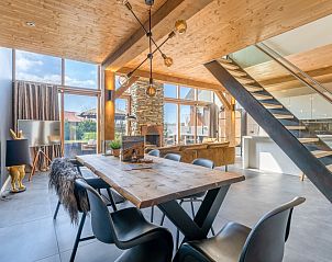 Stylish dining area with wooden table in Villa 181 with Hot tub, De Koog Texel.
