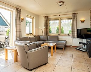 Cozy living room of Villa pet-free in De Koog, Texel with comfortable seating area and lots of natural light.