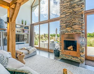 View from the living room of Villa 193, De Koog, Texel, with fireplace and access to terrace.