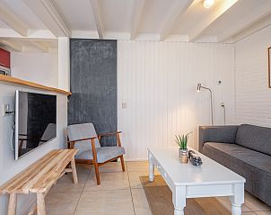 Cozy living room in vacation home 32b Pollux, De Koog, Texel with comfortable seating area.