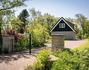 Eingang zum Landhuis De Wije Blick, Ferienhaus in De Koog, Texel, mit Eingangstor und grner Umgebung.