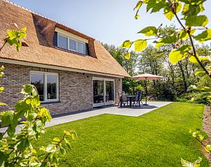 Terrasse von Landhuis De Wije Blick, Ferienhaus in De Koog, Texel, mit Gartenmbeln und grner Umgebung.