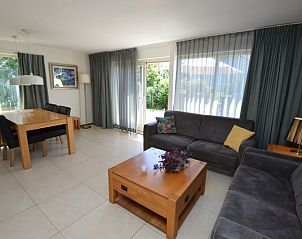 Spacious living room of Holiday home Stappeland 163, De Koog, Texel, with lots of natural light and comfortable furniture.