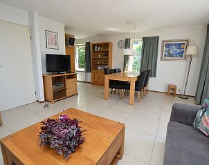 Dining room in Holiday home Stappeland 163, De Koog, Texel, with wooden table and modern furnishings for cozy meals.