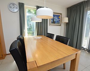 Stylish dining area in Holiday home Stappeland 163, De Koog, Texel, overlooking the green surroundings.