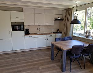 Modern kitchen in Bungalow 5100, De Koog, Texel with dining table and view.