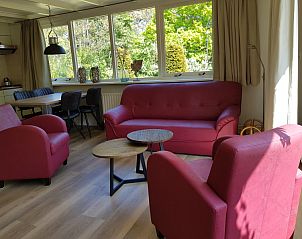 Spacious living room of Bungalow 5100 on Texel with lots of light.