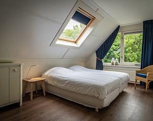 Master bedroom in Villa 6 persons with 2 bathrooms, De Koog, Texel. Spacious vacation home with a view of nature.