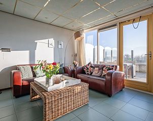 Cozy living room of Resort De Buteriggel - Apartment 9, De Koog, Texel with comfortable sofas and views of nature.