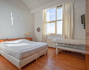 Bright bedroom in Resort De Buteriggel - Apartment 9, De Koog, Texel with large window and comfortable bed.