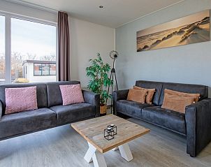 Stylish sitting area in Chalet Bregkoog 261, Chaletpark Bregkoog, De Koog, Texel. Spacious windows with views of nature.