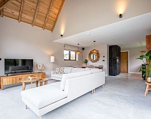 Stylish interior of Villa Jolie vacation home in De Koog, Texel, with modern decor and wooden accents.