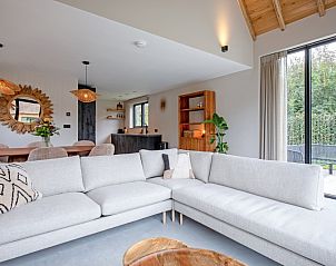Villa Jolie in De Koog, Texel, with spacious sitting area and access to the terrace overlooking nature.