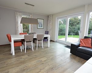 Dining room in Holiday home Stappeland 76, De Koog, Texel overlooking green garden.