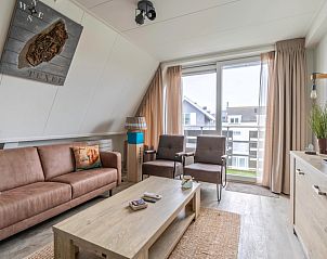 Bright living room of Apartment Anna 222, vacation accommodation in De Koog, Texel, with modern furnishings and balcony view.
