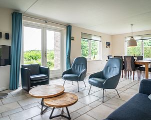 Spacious living room in Villa 6 persons, De Koog, Texel. Comfortable sitting area overlooking the garden of this vacation home on the Wadden Islands.