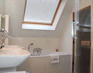 Luxury bathroom in Villa 6 persons, De Koog, Texel. Equipped with bath and shower for relaxation on the Wadden Islands.