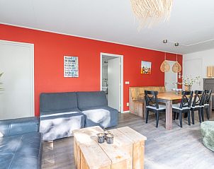 Dining room of Bungalow De Nagtegaal 21 in De Koog Texel, with spacious table and atmospheric lighting.