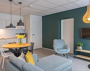 Cozy interior of Apartment 4 persons in De Koog, Texel with open kitchen and comfortable sitting area.