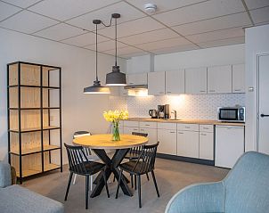 Open kitchen and dining area of Apartment 4 persons, De Koog, Texel with modern amenities.