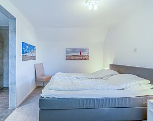 Comfortable bedroom in Holiday home Honeysuckle 93 with sauna, De Koog, Texel, with ensuite bathroom.