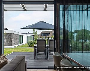 Luxury family villa with pool in De Koog, Texel. Modern kitchen overlooking the Wadden Islands garden.