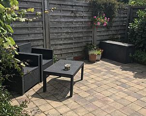 Sunny terrace with seating at Zomerhuisje Schoo, De Koog, Texel, vacation home on the Wadden Islands.