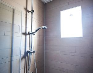 Modern shower in Villa 3, vacation home De Koog Texel, with stylish finish.