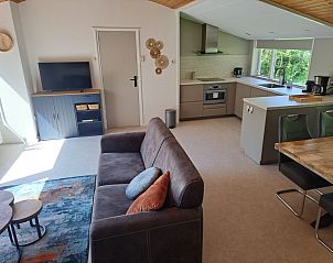 Modern living room in vacation home Hoog Koog 10, Bungalowpark Hoog Koog, De Koog, Texel with open kitchen.