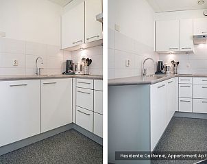 Fully equipped kitchen in Type 4 vacation home, De Koog, Texel. Modern amenities and sleek finish.