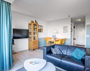 Modern seating area in Apartment Juliana 068 Island and Sea View, De Koog, Texel with flat-screen TV and dining area.