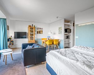 Spacious room in Apartment Juliana 068 Island and Sea View, De Koog, Texel with sitting area and dining area.